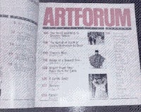 the artforum magazine is open on a table